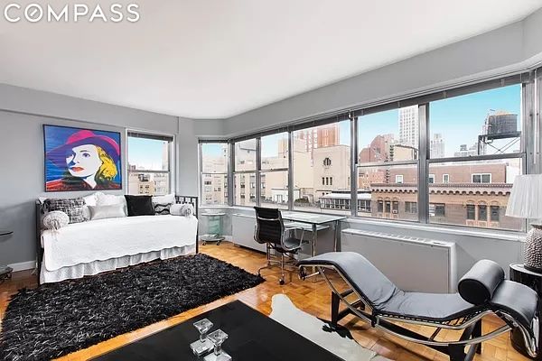 bedroom with light parquet floors and multiple windows