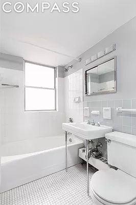 bathroom featuring toilet, tile patterned flooring, tile walls, and tiled shower / bath