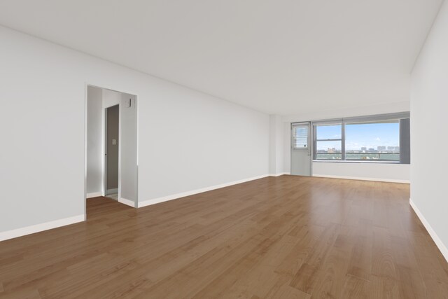 empty room with radiator and light wood-type flooring