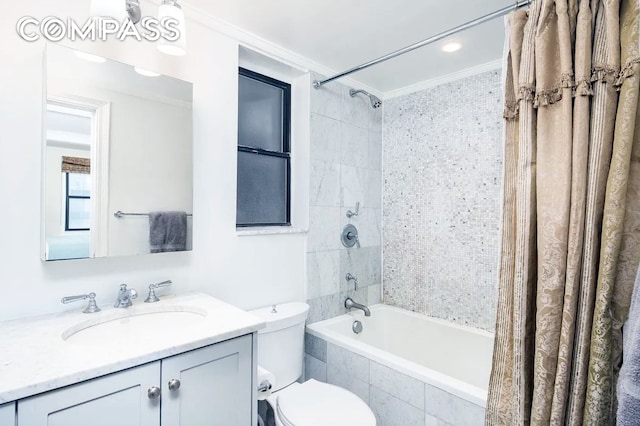 full bathroom with vanity, toilet, tiled shower / bath, and ornamental molding