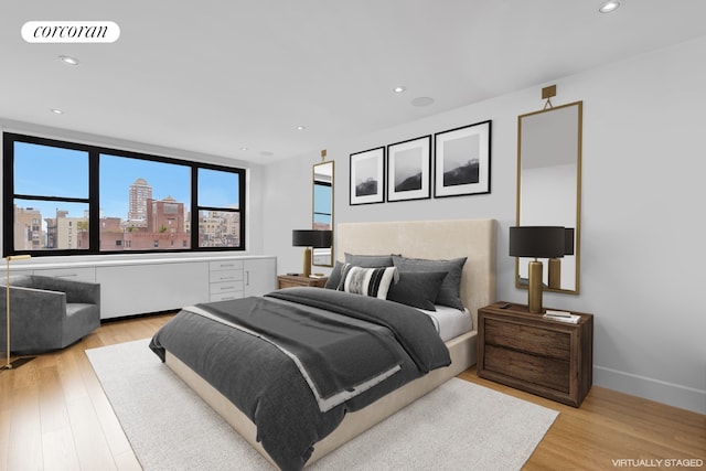 1474 3rd Ave Unit 16Ns, New York City, NY 10028 - bedroom with light wood-type flooring, recessed lighting, a view of city, and baseboards