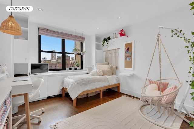 bedroom with dark hardwood / wood-style floors