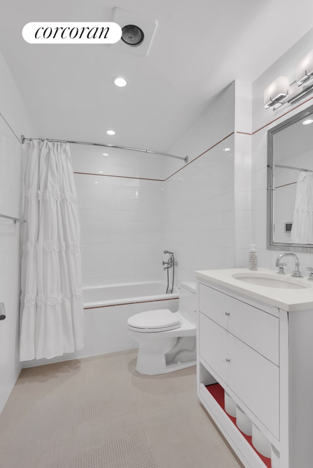full bathroom featuring tiled shower / bath combo, toilet, vanity, and tile patterned flooring