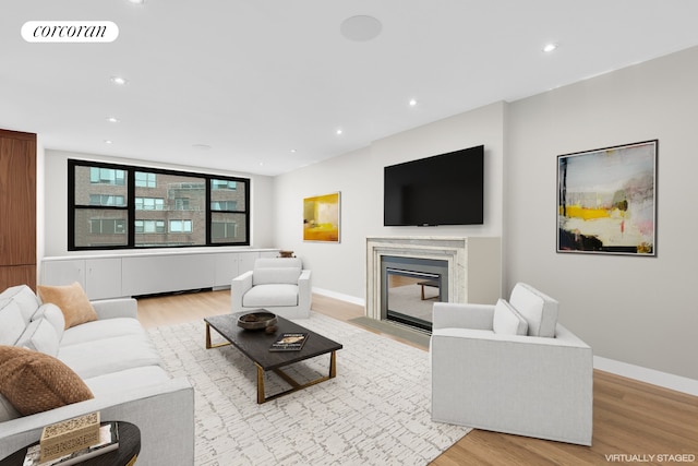 1474 3rd Ave Unit 16Ns, New York City, NY 10028 - living room featuring light wood-type flooring, recessed lighting, a high end fireplace, and baseboards