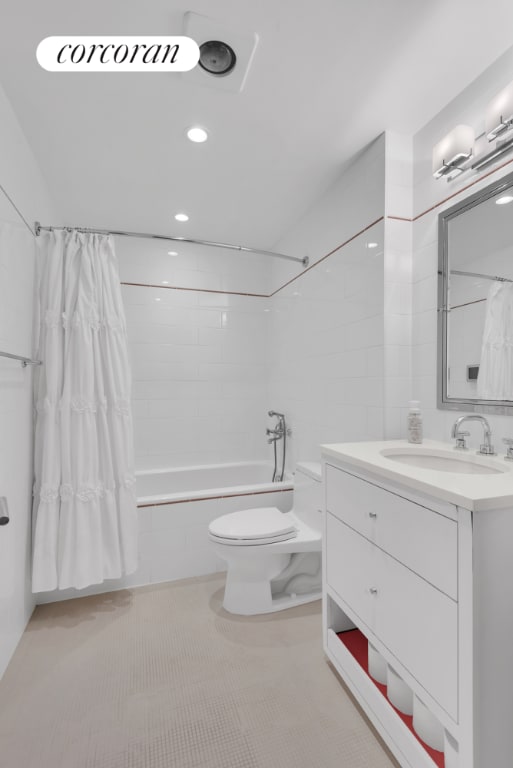 full bathroom featuring toilet, vanity, shower / bathtub combination with curtain, and tile patterned flooring