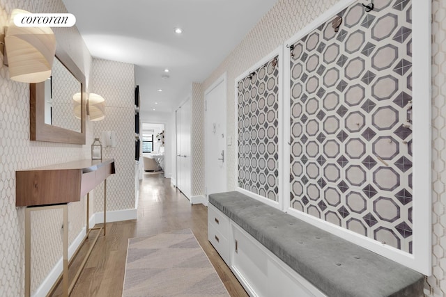 hall featuring recessed lighting, baseboards, wallpapered walls, visible vents, and wood finished floors
