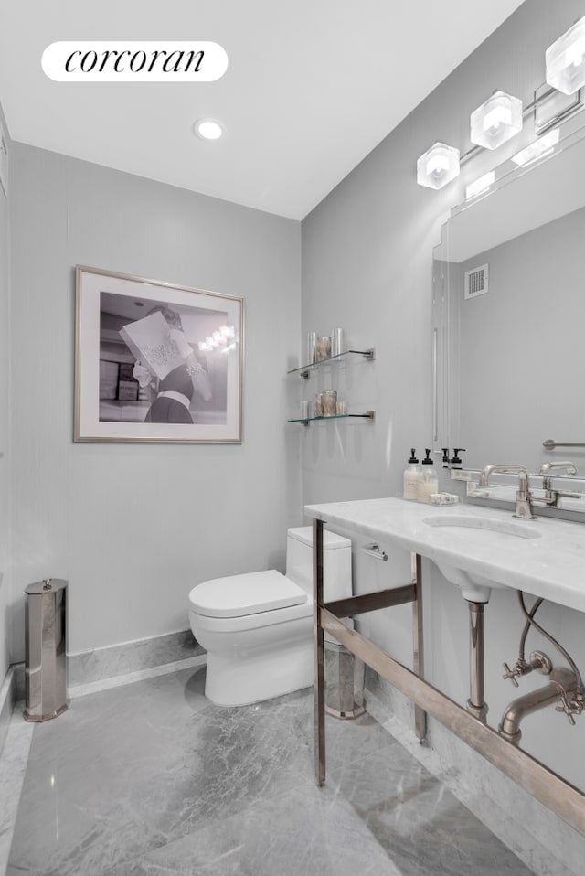 1474 3rd Ave Unit 16Ns, New York City, NY 10028 - half bath with toilet, marble tiled floors, and recessed lighting
