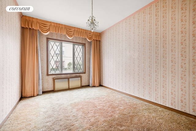 spare room with carpet, baseboards, wallpapered walls, an inviting chandelier, and radiator heating unit