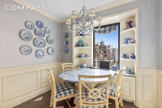 dining room featuring ornamental molding and a notable chandelier