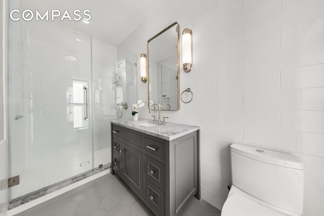 110 W 81st St, New York City, NY 10024 - bathroom featuring vanity, toilet, a shower stall, tile patterned floors, and tile walls