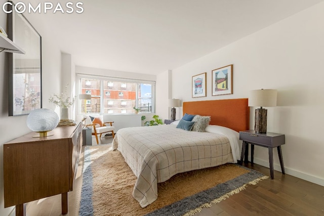 bedroom with dark wood-type flooring