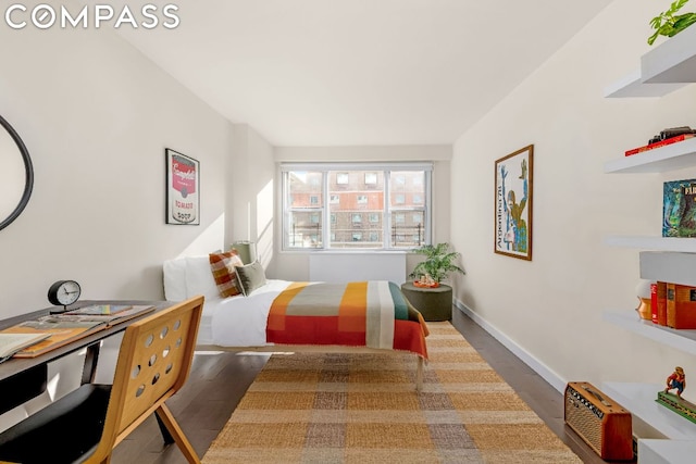 bedroom with dark hardwood / wood-style floors