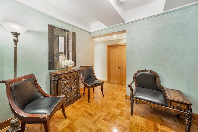 living room with a tray ceiling and built in shelves