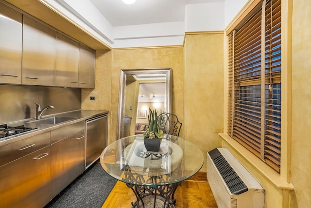 kitchen with heating unit, parquet flooring, sink, and stainless steel appliances