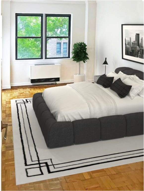 bedroom with radiator and light parquet flooring