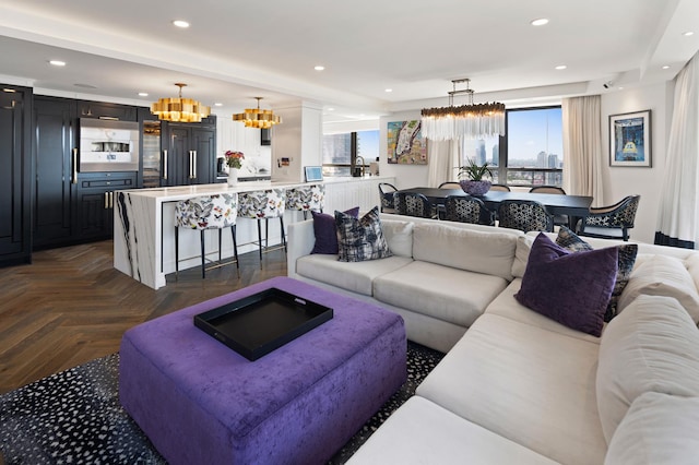 living area featuring recessed lighting and a notable chandelier