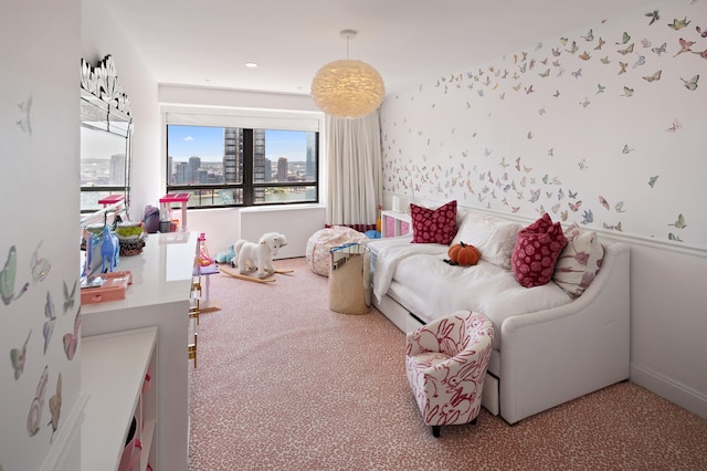 bedroom with wallpapered walls, a city view, and carpet flooring