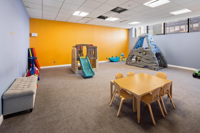 recreation room featuring a paneled ceiling, baseboards, visible vents, and carpet flooring