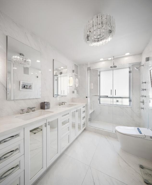 bathroom featuring toilet, tile walls, and a sink