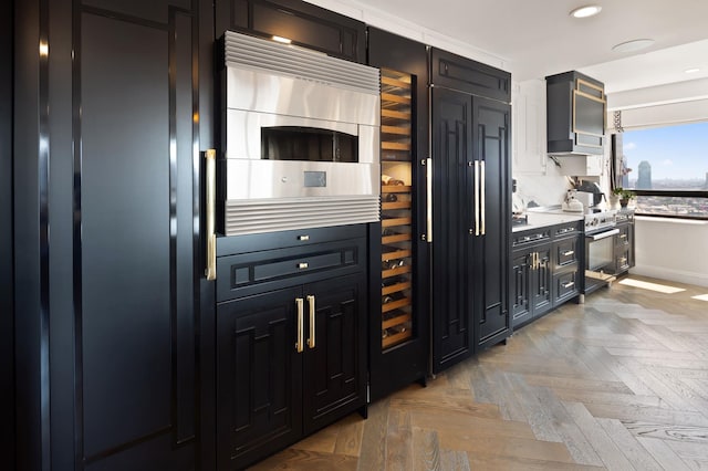 kitchen featuring stainless steel electric range, recessed lighting, light countertops, wall chimney exhaust hood, and dark cabinets