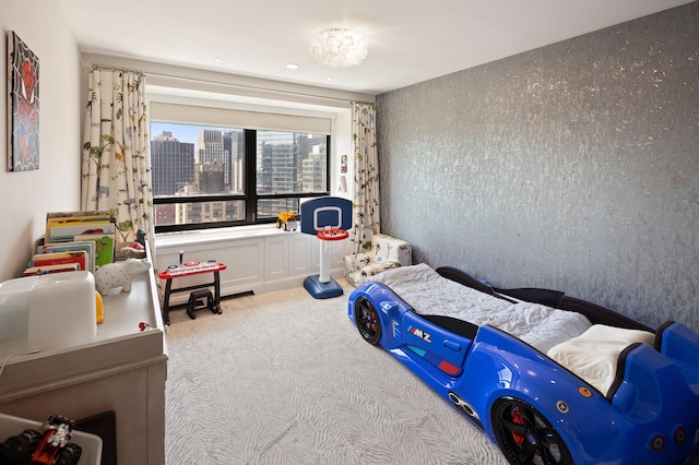 carpeted bedroom with a view of city