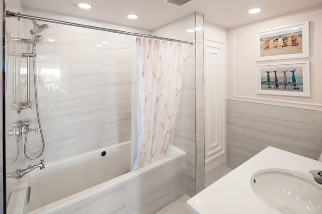 bathroom with recessed lighting, shower / bathtub combination with curtain, visible vents, and a sink