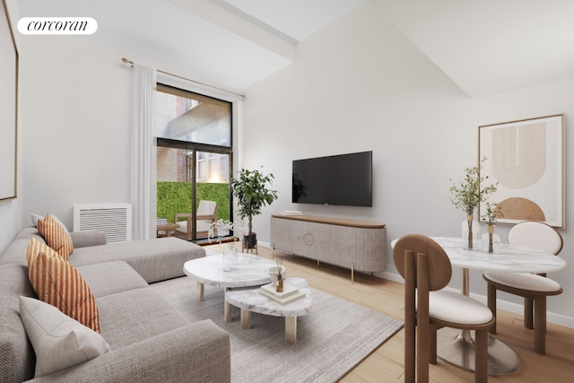 living room featuring vaulted ceiling and light hardwood / wood-style floors