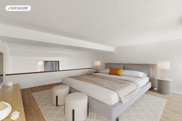 bedroom featuring a textured ceiling and light hardwood / wood-style flooring