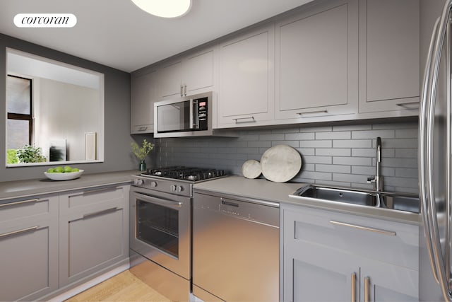 kitchen with light countertops, visible vents, decorative backsplash, appliances with stainless steel finishes, and a sink