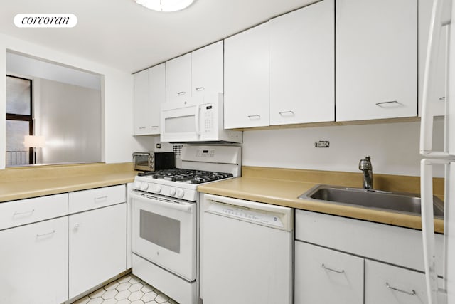 kitchen featuring white cabinets, light tile patterned floors, sink, and white appliances