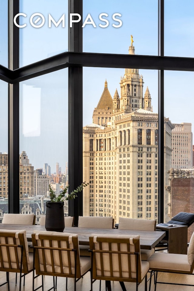 dining space featuring a wall of windows and a city view