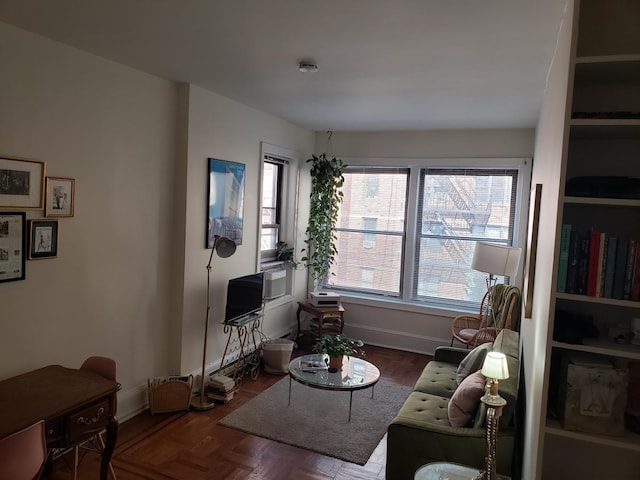 living area featuring baseboards