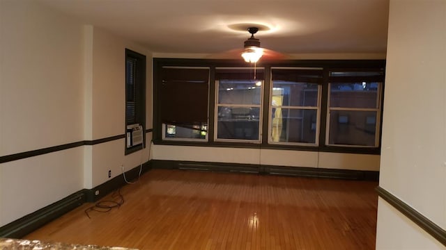 empty room with baseboards and wood finished floors