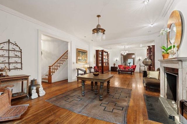 dining room with hardwood / wood-style flooring, crown molding, and a notable chandelier