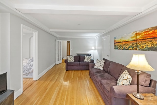 living room featuring beam ceiling and light wood-type flooring