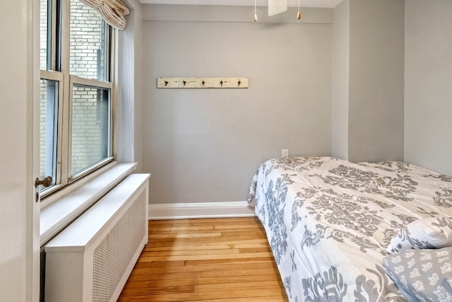 424 E 52nd St Unit 3D, New York City, NY 10022 - bedroom with radiator heating unit and hardwood / wood-style floors
