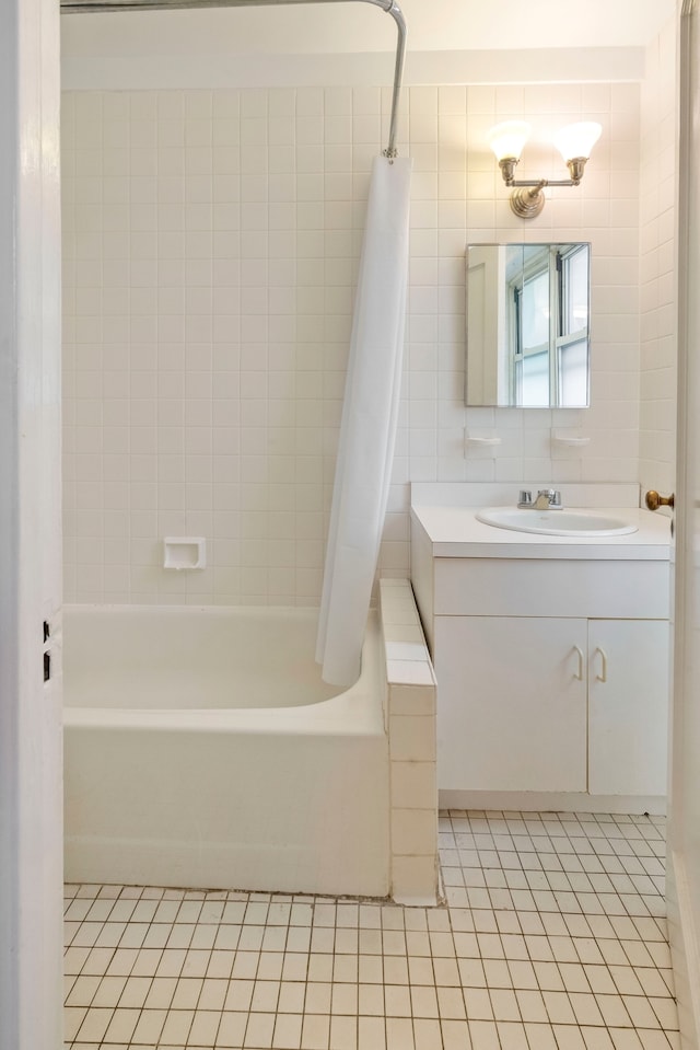 424 E 52nd St Unit 3D, New York City, NY 10022 - bathroom with tile patterned floors, shower / bath combo, and vanity