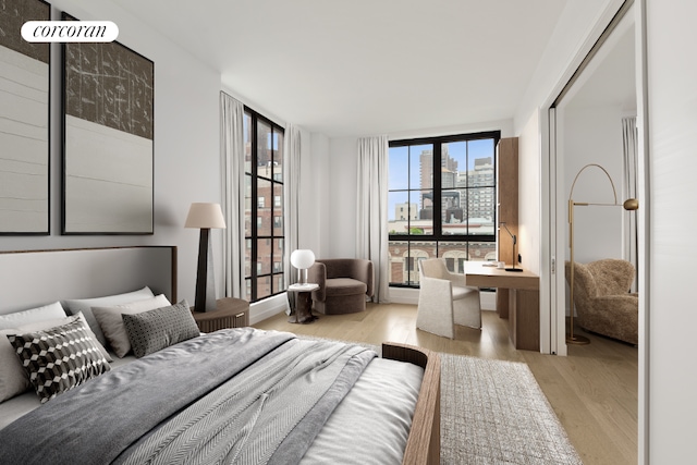 bedroom with floor to ceiling windows and light hardwood / wood-style floors