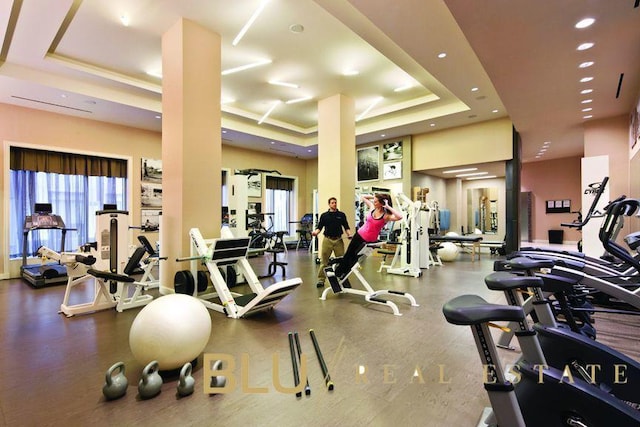 exercise room featuring a tray ceiling