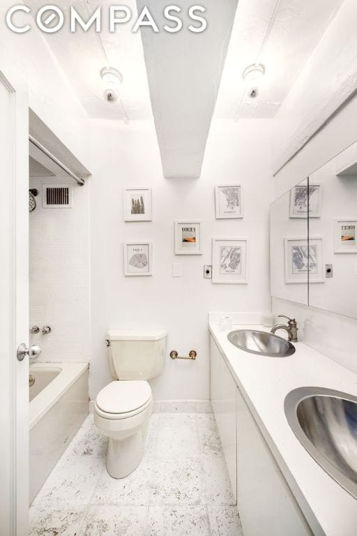 full bathroom with toilet, vanity, tile patterned flooring, and tiled shower / bath