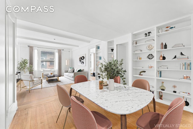 dining space with built in features and light wood-type flooring