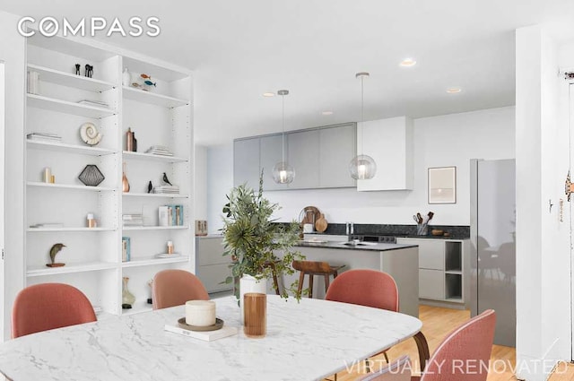 dining area with recessed lighting and light wood-type flooring