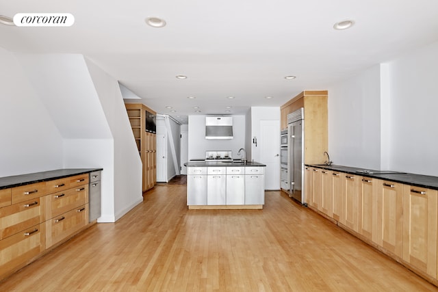 kitchen featuring light hardwood / wood-style floors, sink, light brown cabinets, and white cabinets