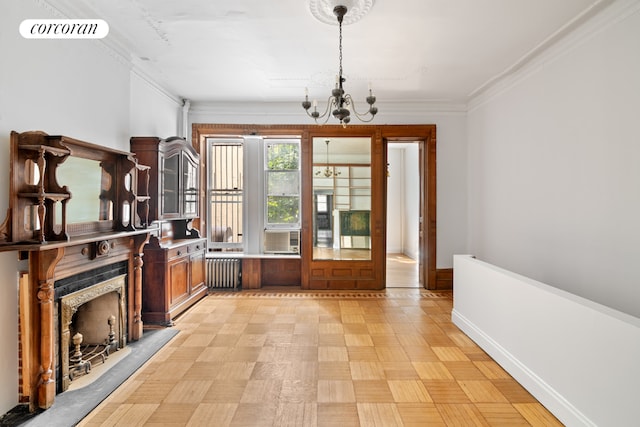 interior space with light parquet floors, a notable chandelier, a premium fireplace, radiator, and ornamental molding