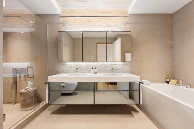 bathroom featuring vanity, shower with separate bathtub, and tile walls