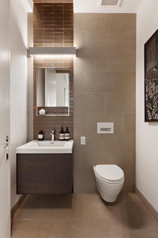 bathroom with tile walls, tile patterned floors, vanity, and toilet