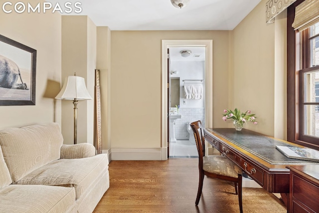 home office with light hardwood / wood-style floors