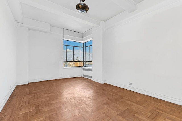 empty room with baseboards, radiator heating unit, and beamed ceiling
