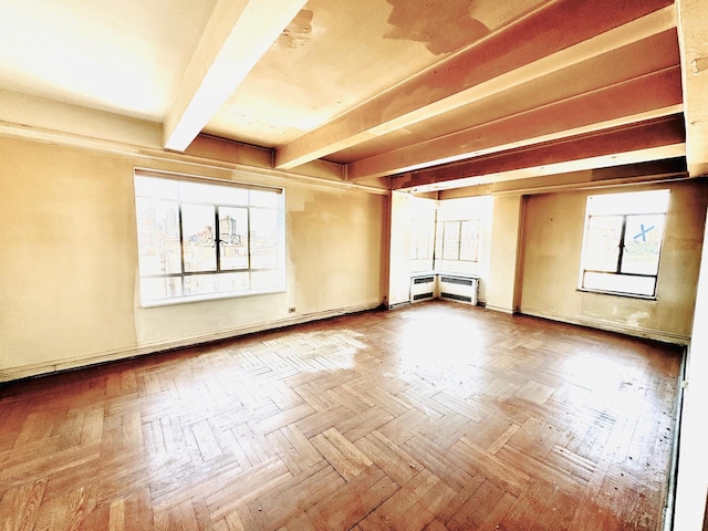 empty room featuring beamed ceiling