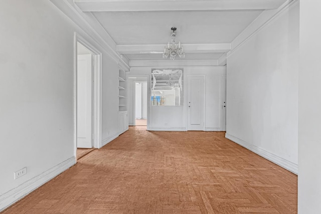 unfurnished room with baseboards, a notable chandelier, and beamed ceiling